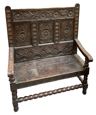 Lot 22 - A 18th/19th century carved oak bench/settle,...