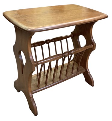 Lot 43 - ERCOL; a mid century medium elm newspaper...