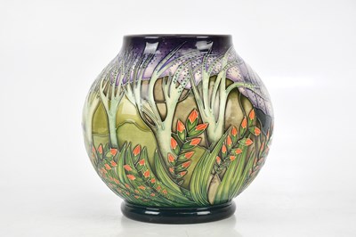 Lot 90 - MOORCROFT; a bulbous trial vase, decorated...