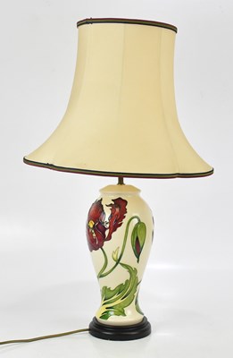 Lot 78 - MOORCROFT; a large table lamp, decorated in...