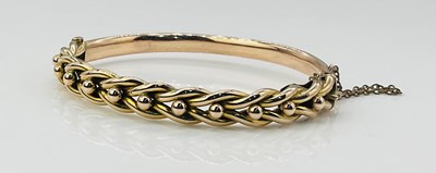Lot 799 - A 9ct yellow and rose gold oval hinged snap...