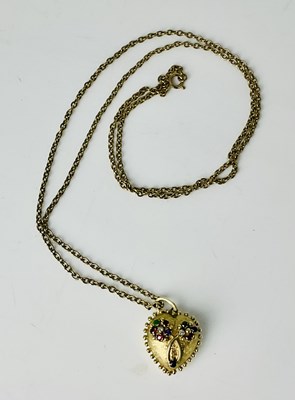 Lot 801 - A yellow metal gem set heart shaped pendant,...