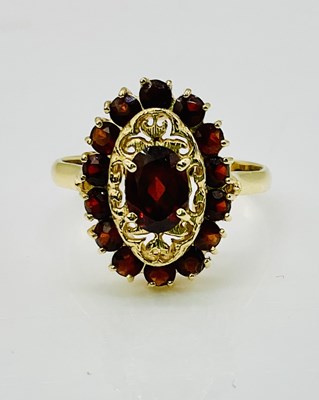 Lot 803 - An 18ct yellow gold garnet set ring, size Q,...