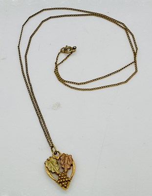 Lot 817 - A three tone yellow metal grape and leaf...