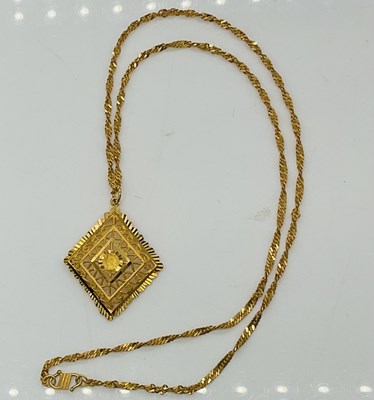 Lot 821 - A 22ct pierced lozenge shaped pendant,...