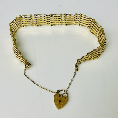 Lot 823 - A 9ct yellow gold four bar gate link bracelet,...
