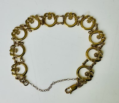 Lot 825 - A 9ct yellow gold bracelet formed of open hand...