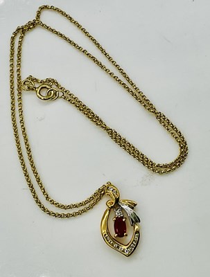 Lot 828 - An 18ct yellow gold diamond and ruby pendant...