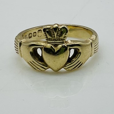Lot 834 - A 14ct yellow gold hand and heart ring,...