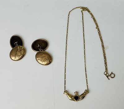 Lot 838 - A 9ct yellow gold hand and heart necklace,...