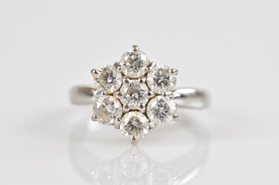 Lot 2273 - An 18ct white gold daisy cluster ring, set...