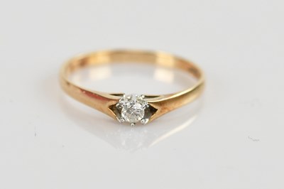Lot 521 - A 9ct gold diamond solitaire ring with a small...