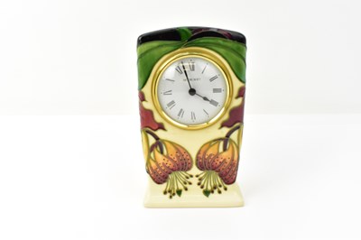 Lot 126 - MOORCROFT; an 'Anna Lily' pattern table clock,...
