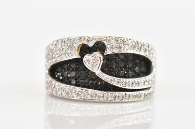 Lot 473 - An 18K white gold contemporary ring, the love...
