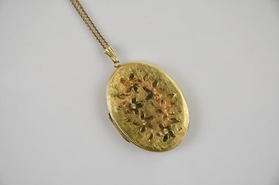 Lot 529 - A 9ct gold large oval double locket, with...