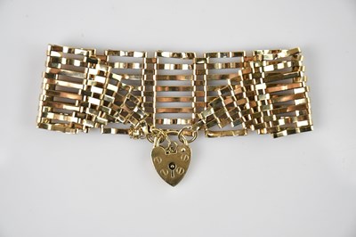 Lot 569 - A 9ct gold eight bar gate bracelet, united...