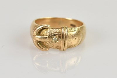 Lot 502 - A 9ct gold buckle ring, with tiny star set...