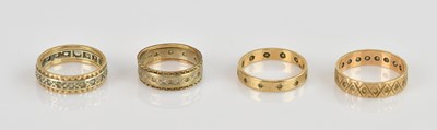 Lot 487 - Four 9ct gold eternity rings, each inset with...