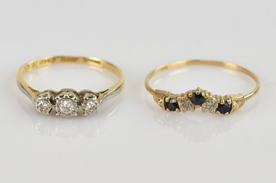 Lot 514 - An 18ct gold ring set with three tiny diamonds...