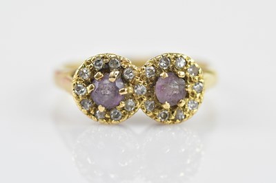 Lot 480 - An 18ct gold ring with two circular heads,...