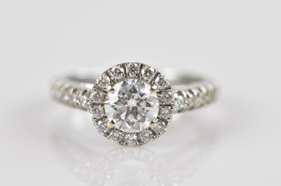 Lot 2262 - A white metal diamond set halo ring, the...
