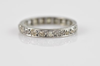 Lot 2453 - A white metal diamond set full eternity ring,...