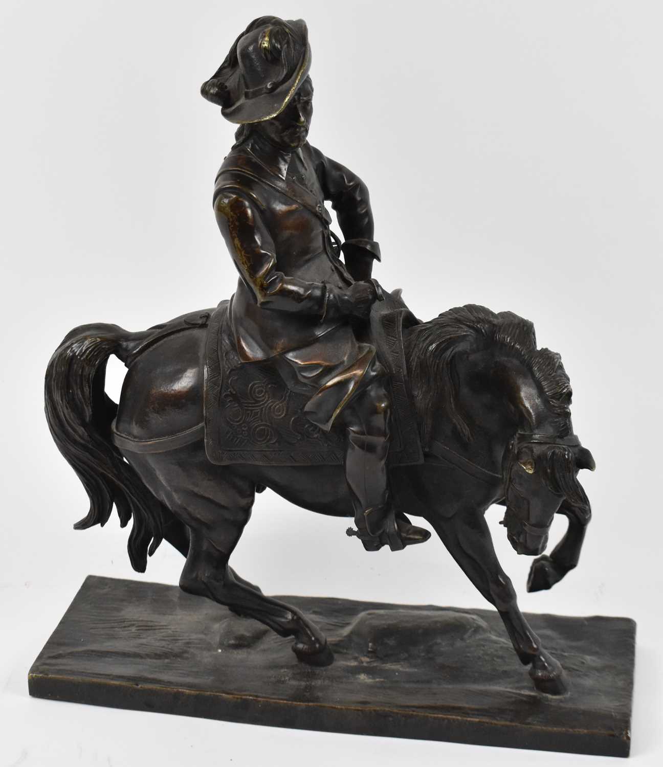 Lot 385 - A bronze figure of a cavalier on horseback,