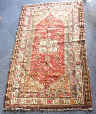 Lot 66 - A large red Turkish rug, 215 x 127cm.