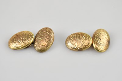 Lot 556 - A pair of 9ct gold oval cufflinks with floral...
