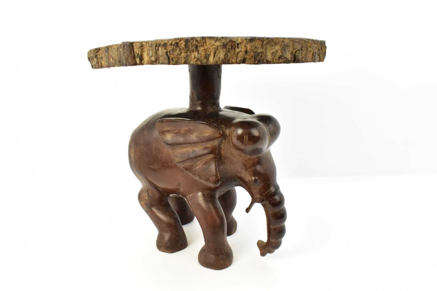 Lot 7 - A carved one-piece coffee table in the form of...