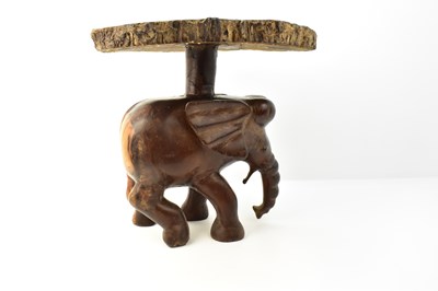 Lot 7 - A carved one-piece coffee table in the form of...
