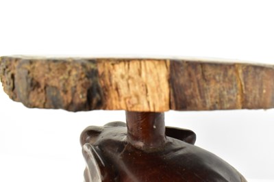 Lot 7 - A carved one-piece coffee table in the form of...