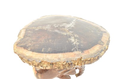 Lot 7 - A carved one-piece coffee table in the form of...