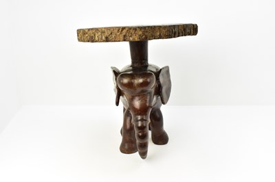 Lot 7 - A carved one-piece coffee table in the form of...