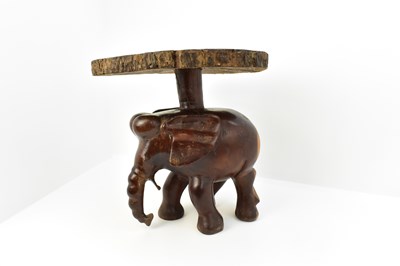 Lot 7 - A carved one-piece coffee table in the form of...