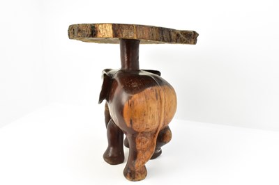 Lot 7 - A carved one-piece coffee table in the form of...