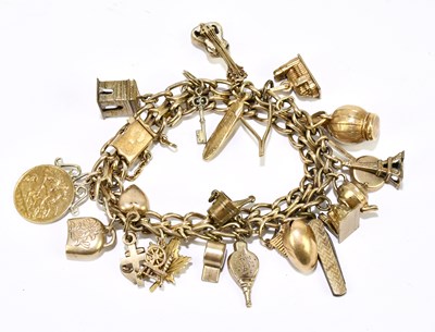 Lot 1259 - A gold plated charm bracelet, housing a...
