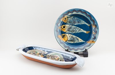 Lot 136 - An elongated tin glazed earthenware twin...