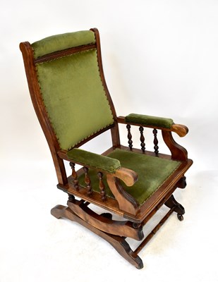 Lot 46 - A stained beech American rocking chair with...