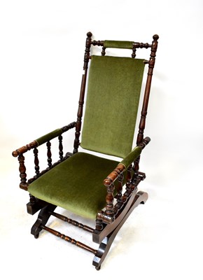 Lot 47 - A walnut framed American rocking chair with...