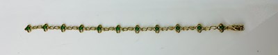 Lot 903 - A 9ct gold and emerald line bracelet (clasp...