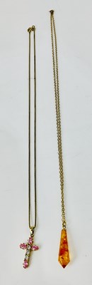 Lot 912 - Two yellow metal chains with pendants,...