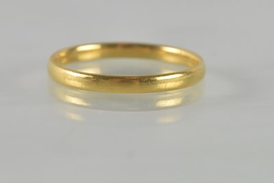 Lot 497 - A 22ct yellow gold wedding band, size N,...