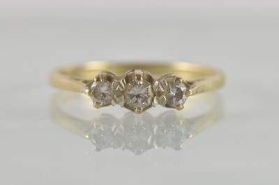 Lot 496 - A 9ct yellow gold diamond set three stone ring,...