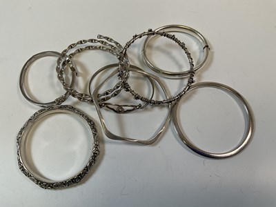 Lot 958 - Eight silver bangles, combined approx...