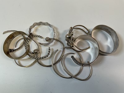 Lot 960 - Ten silver and white metal cuff or open...
