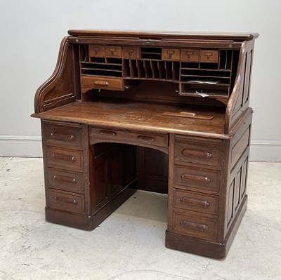 Lot 122 - A 1920s roll top oak desk, with an arrangement...