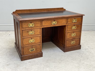 Lot 117 - A 19th century oak kneehole desk, with an...