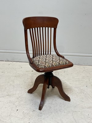 Lot 179 - A 1930s oak revolving office chair, with...