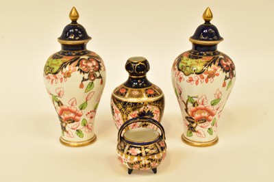 Lot 146 - ROYAL CROWN DERBY; a pair of small temple jars...